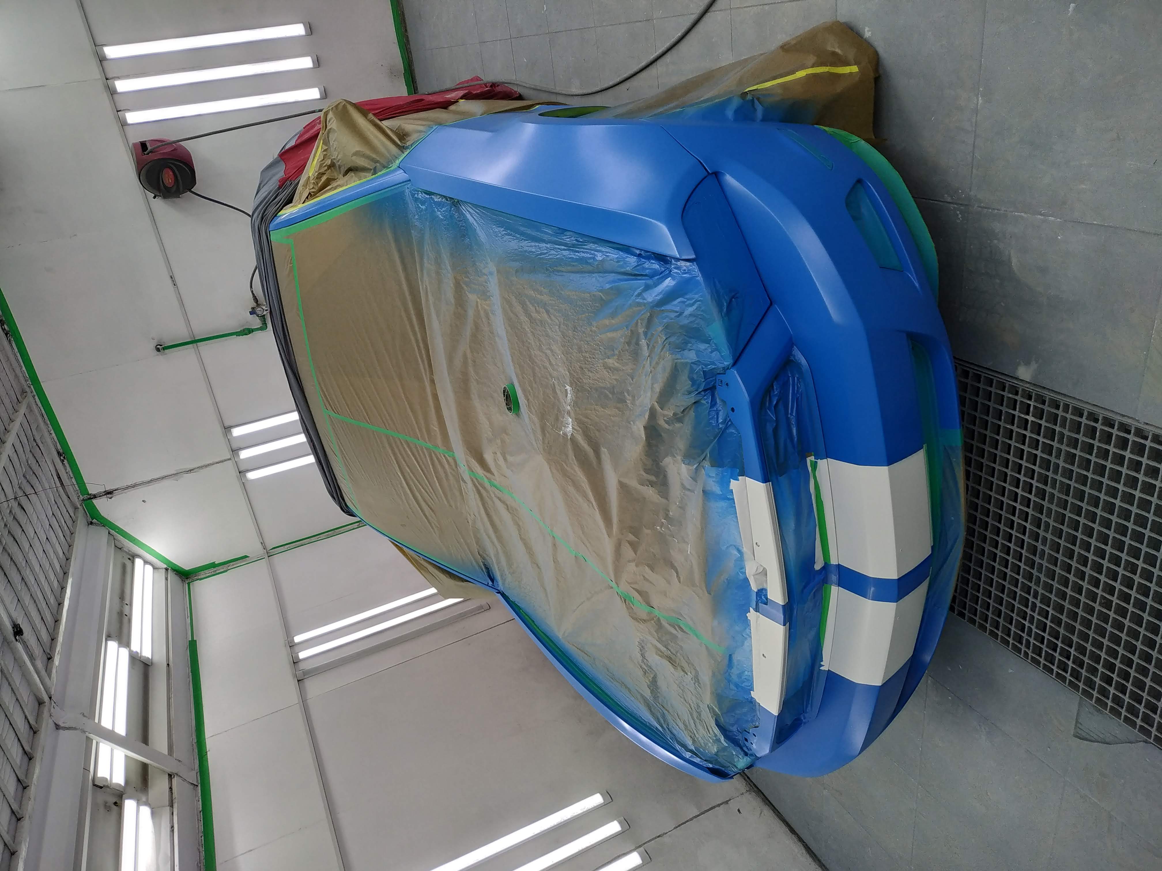 Blue helicopter body in booth